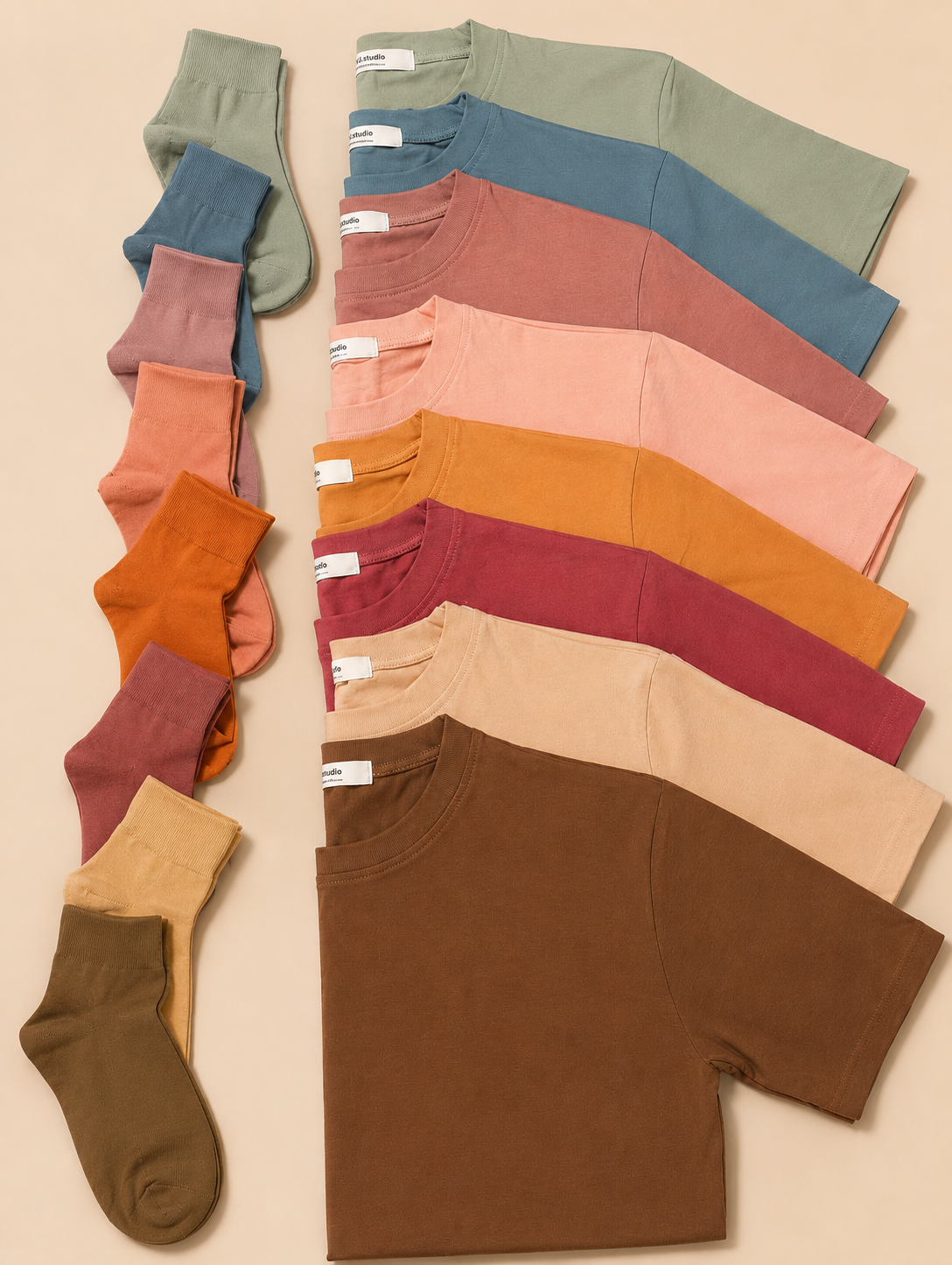 Collection of colorful socks and t-shirts on a beige background