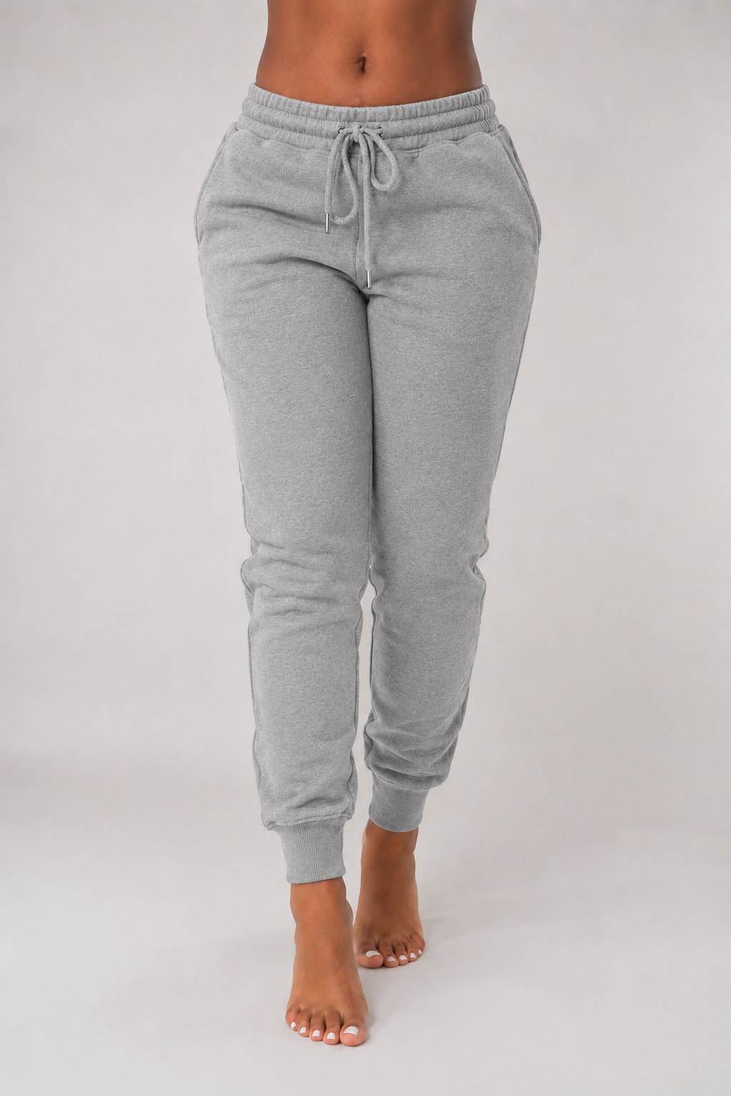 Gray sweatpants worn by a person on a plain background