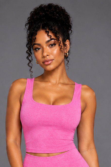 Woman wearing a pink athletic outfit on a gray background