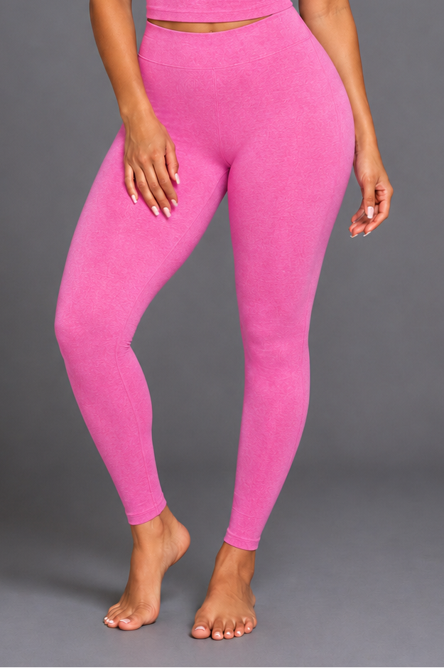 Woman wearing a pink athletic outfit on a gray background