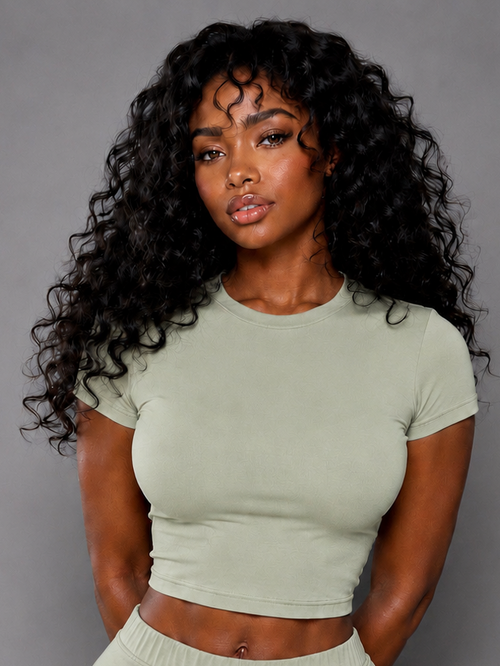 Woman wearing a green outfit against a gray background